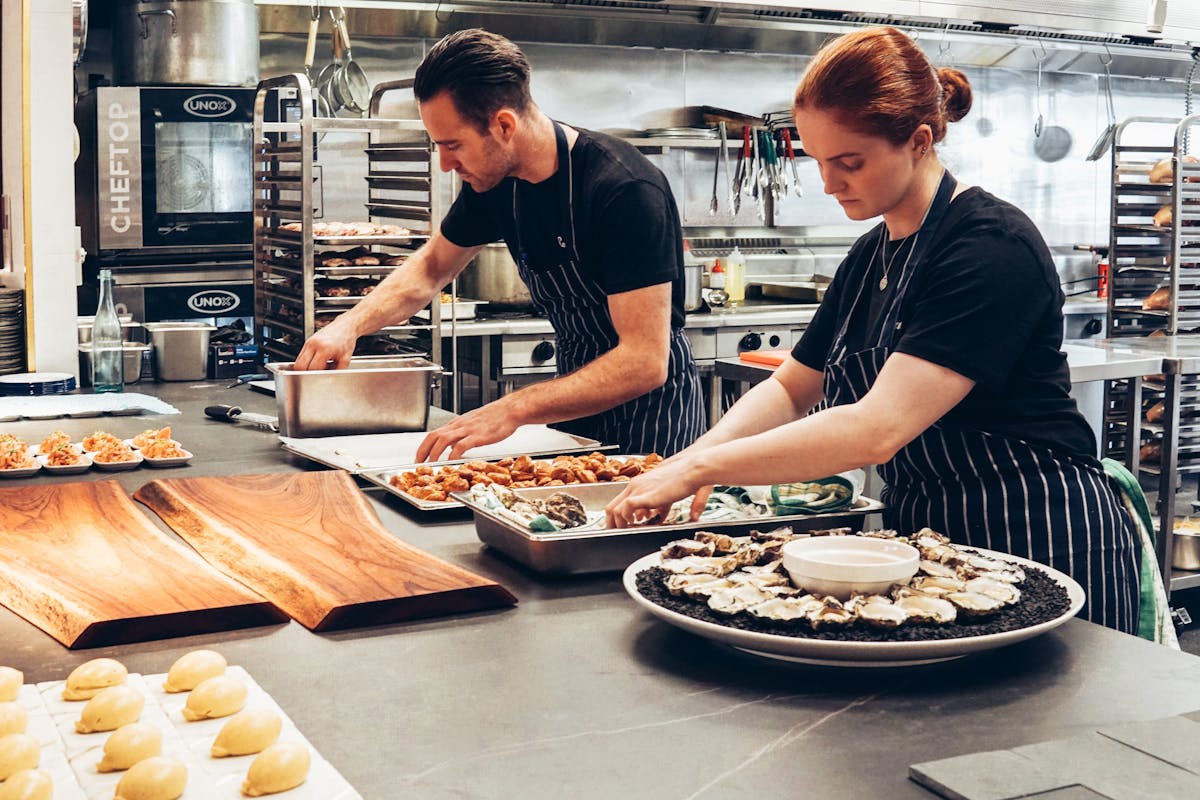 Chef inspecting food quality in kitchen